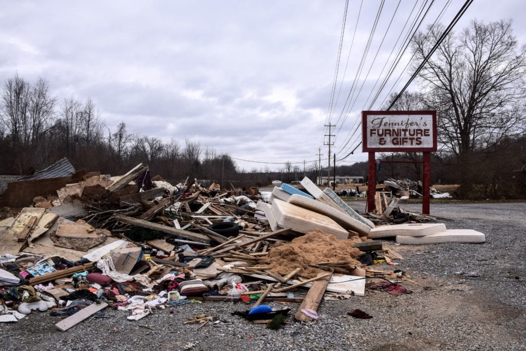 Wreckage from the August flood in Waverly sits in a pile outside a furniture shop on Highway 70.