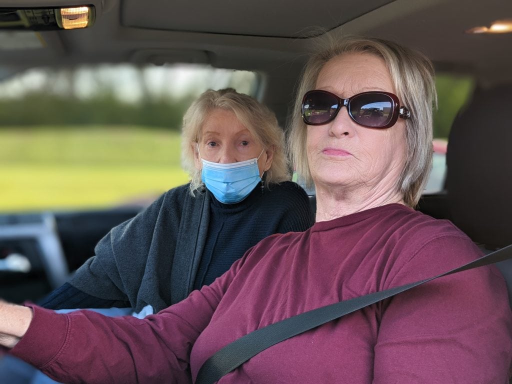 Susan and Anne sat in their car to wait in line for food at a OneGenAway mobile food pantry distribution.