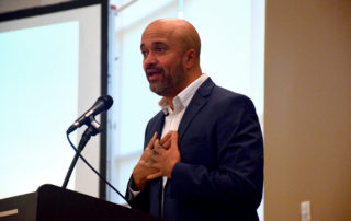 Carlos Whittaker speaks on stage at the 2022 Million Meal Spring Breakfast.