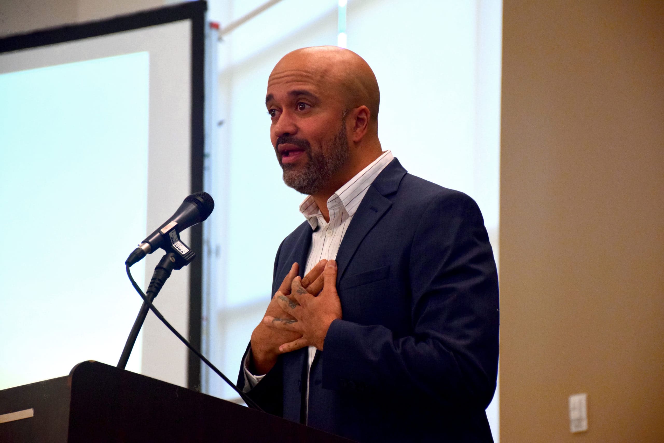 Carlos Whittaker speaks on stage at the 2022 Million Meal Spring Breakfast.