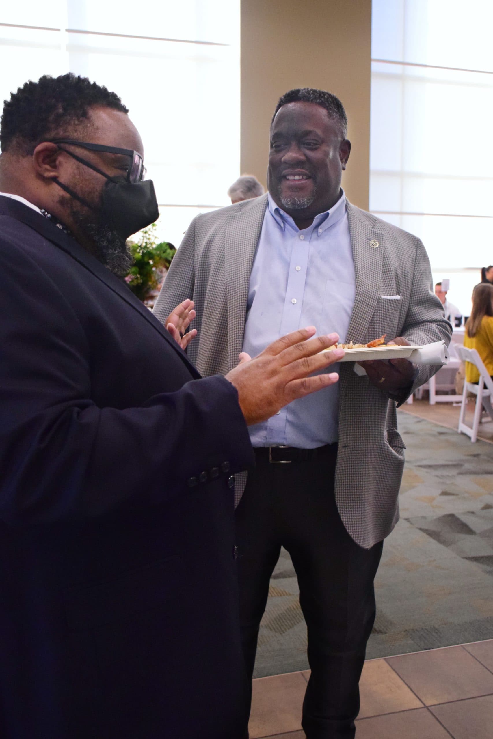 Walter Simmons and Kevin Townsel chat at the 2022 Million Meal Spring Breakfast.