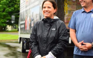Maria Lee welcomes and instructs volunteers at a OneGenAway mobile food pantry in Jonesborough, Tennessee