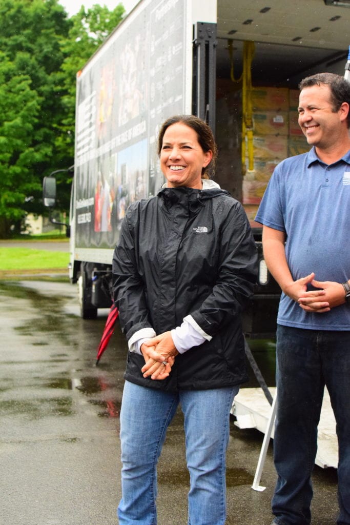 Maria Lee welcomes and instructs volunteers at a OneGenAway mobile food pantry in Jonesborough, Tennessee