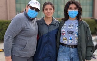 Mely, Sabrina, and Nicole volunteer at OneGenAway's mobile food pantry.