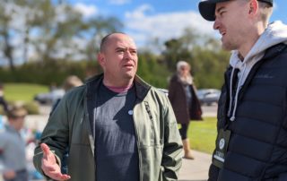 Tim chats with a volunteer at OneGenAway's mobile food pantry.