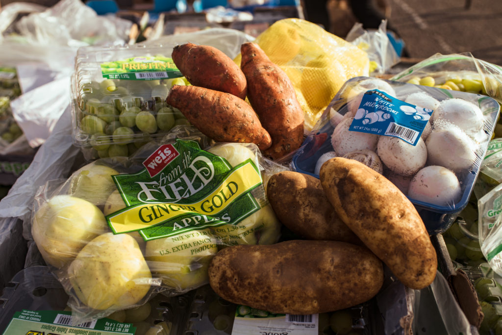 Apples, grapes, sweet potatoes, russet potatoes, lemons, and mushrooms are all part of the produce haul at OneGenAway's mobile food pantry.
