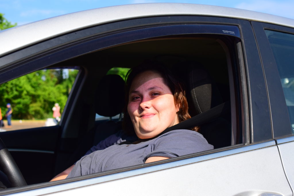 Terry shares a snippet of her story as she receives food at OneGenAway's mobile food pantry.