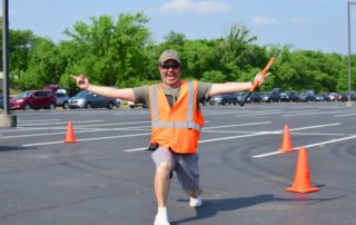 Scott Lucas strikes a pose in the parking lot at OneGenAway's mobile food pantry.