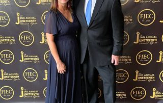 Annette and Rob Doom pose in front of a step-and-repeat wall at Franklin Justice and Equity Coalition's Juneteenth Gala in 2022.